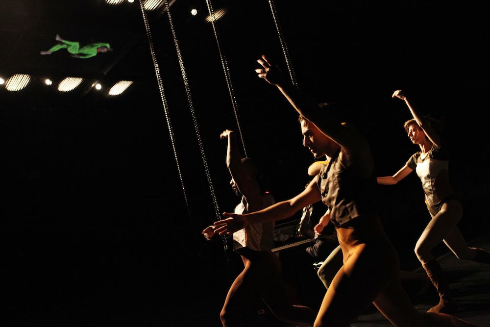 Dancer in Green above a quartet in Brown in Dance Heginbotham's Dark Theater